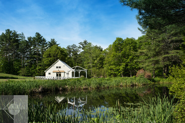 View of the 1812 Farm: Service - Utility Building in Bristol, Maine from across a pond.