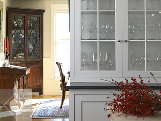 Dry bar with glass front cupboard.