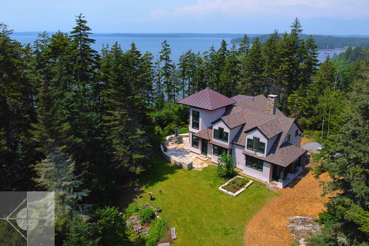 Drone view of this St. George, Maine home and fieldstone patio and retaining wall.