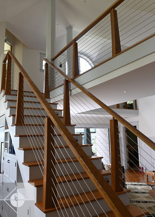 Interior stairs with wood and wire railings.