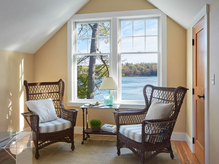 Sitting area of cottage in Edgecomb, Maine by Phelps Architects