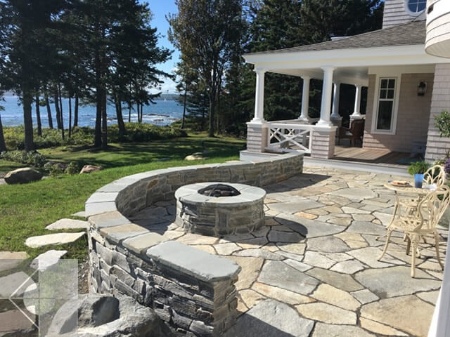 Fieldstone patioe and fire pit with ocean views.