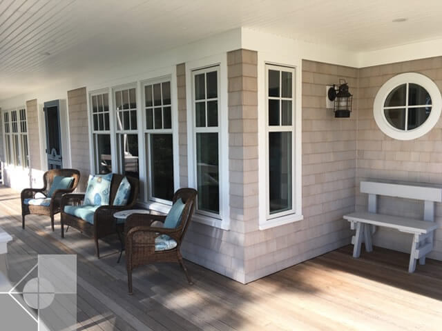 Screened in porch with chairs, bench and custom round window.