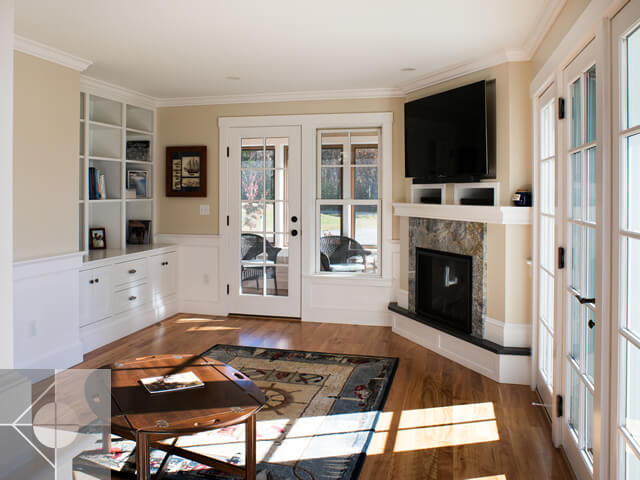 Great room with fieldstone fireplace and built in cabinets.