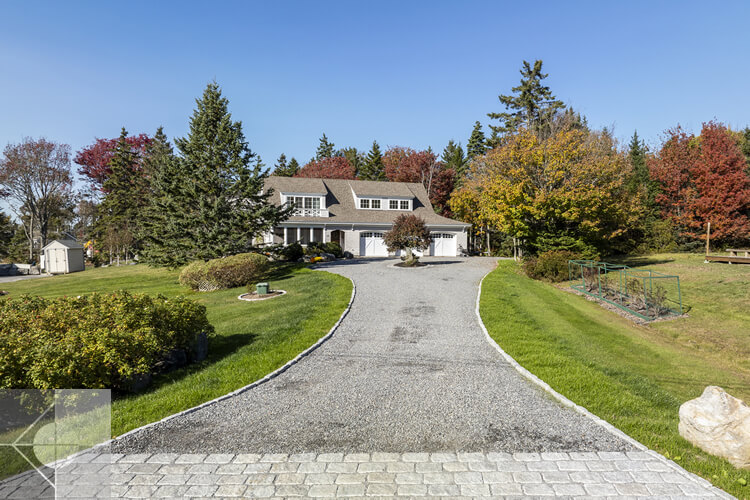 Drone view of this New Harbor home and driveway from the street.