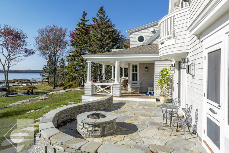 Drone view of the curved fieldstone patio and fire pit.