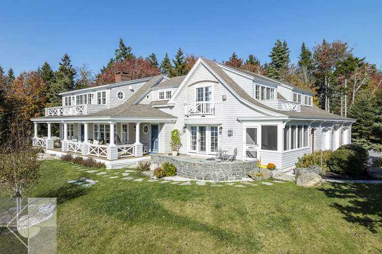 New Harbor, Maine home featuring tiered rock walls and steps in the back yard.