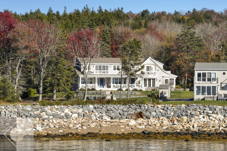View of this New Harbor, Maine home from the ocean and showing a rock retaining wall.