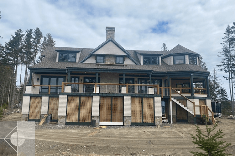 Home under construction featuring a wrap around porch and outdoor stairs.