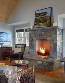 Fireplace and livingroom of this Edgecomb, Maine cottage.